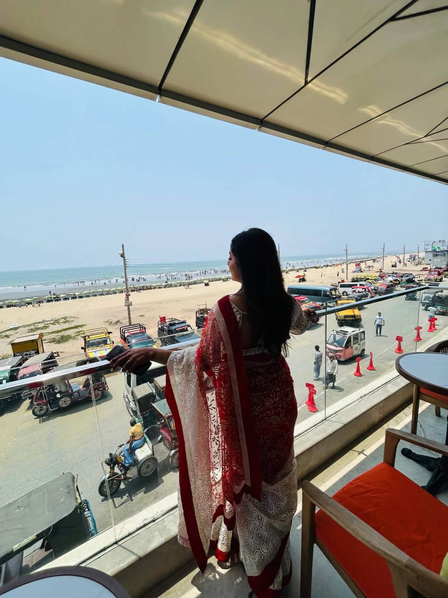 Prety Chowdhury — Ramada Cox's Bazar beach view balcony in red & white saree